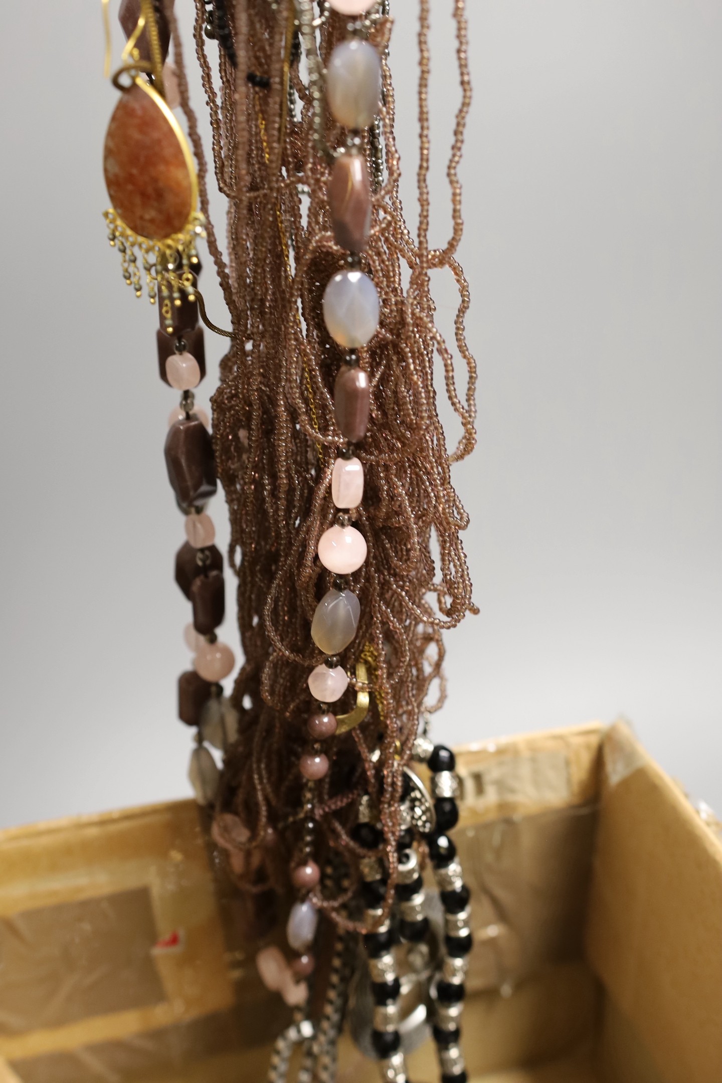 A quantity of assorted costume jewellery including necklaces and minor silver
